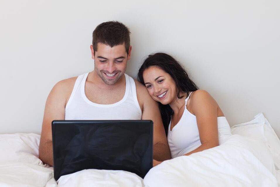 A young couple read reviews about the use of external means of penis enlargement