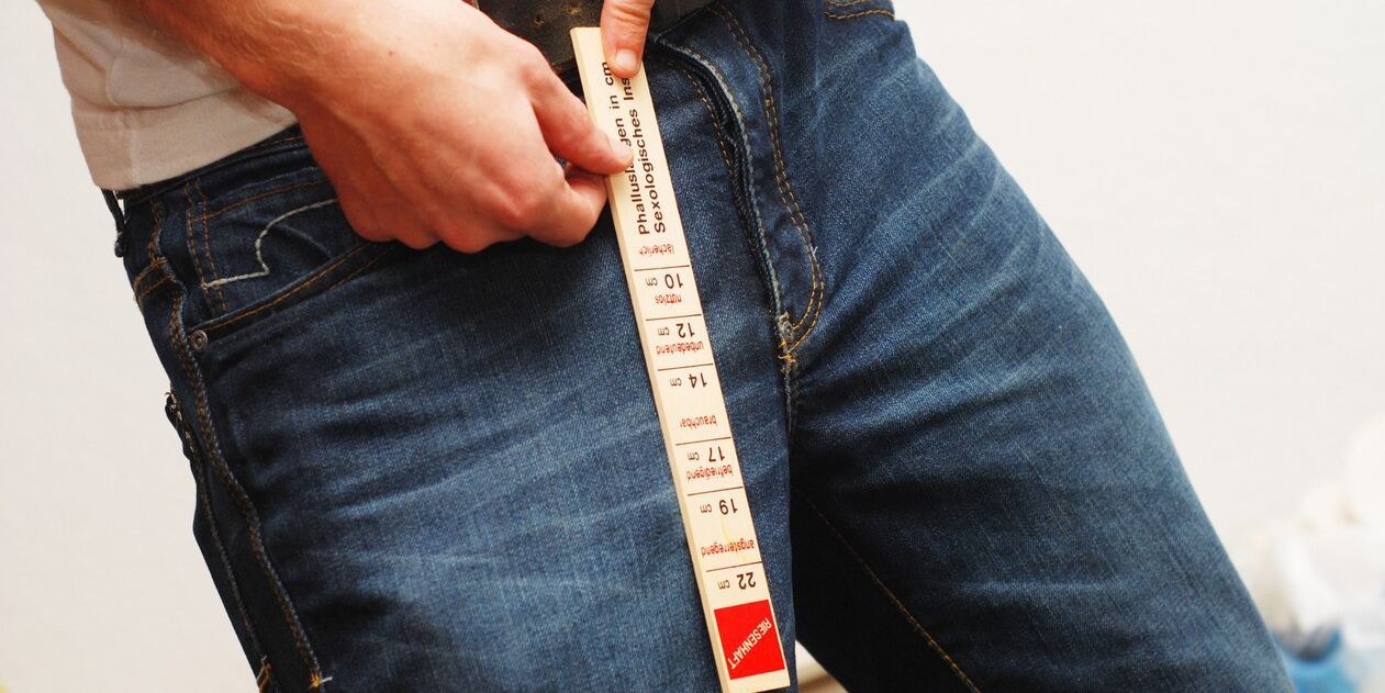 A man measuring his member's length